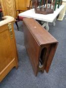 A mid century teak drop leaf table