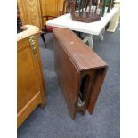 A mid century teak drop leaf table