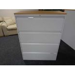 A four drawer metal document cabinet with oak effect top with key