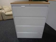 A four drawer metal document cabinet with oak effect top with key