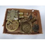 A box of assorted brass ware, trivets, goblets,