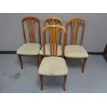 A set of four teak dining chairs