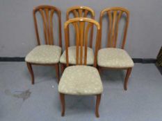 A set of four teak dining chairs