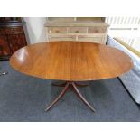 An oval inlaid mahogany pedestal dining table