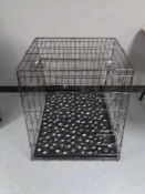 A folding black metal dog cage, height 70 cm, width 68 cm, depth 84 cm.