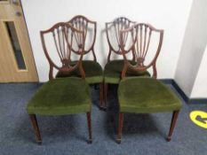 A set of four inlaid mahogany shield backed dining chairs
