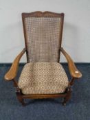 A twentieth century beech framed bergere armchair