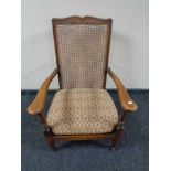 A twentieth century beech framed bergere armchair