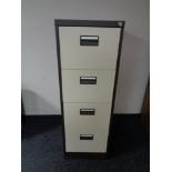 A four drawer metal filing cabinet with key