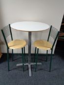 A contemporary poser bar table on metal legs together with two pine seated bar stools