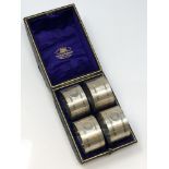 A good set of four silver napkin rings with engine turned decoration, numbered 1 2 3 4,