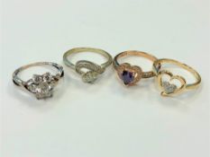 Four white metal dress rings