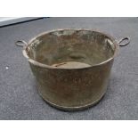 A nineteenth century copper twin handled pot, width 44 cm.