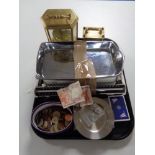 A tray of carriage clocks, foreign coins, bank notes,