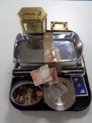 A tray of carriage clocks, foreign coins, bank notes,