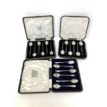 A boxed set of six silver teaspoons and two boxed sets of six silver coffee spoons
