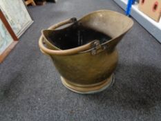 An antique brass coal bucket