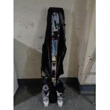 A set of skis and poles in carry bag,