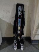 A set of skis and poles in carry bag,