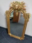 A decorative gilt framed hall mirror.