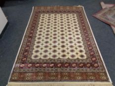 A cream ground Bokhara rug 240 cm x 160 cm