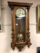 A late 19th century walnut cased Vienna regulator wall clock, with pendulum,