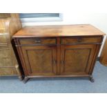 A nineteenth century double door sideboard fitted with two drawers on paw feet