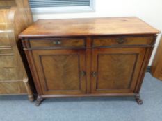 A nineteenth century double door sideboard fitted with two drawers on paw feet