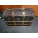 An early twentieth century wooden bound dome topped travelling trunk