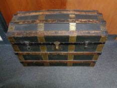 An early twentieth century wooden bound dome topped travelling trunk