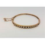 An antique gold and pearl hinged bangle CONDITION REPORT: 8.