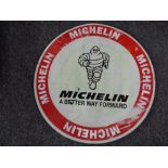 A circular metal sign - Michelin