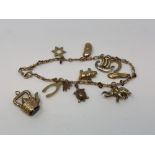 A 9ct gold charm bracelet and one loose charm CONDITION REPORT: 14.
