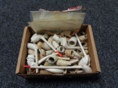 A box of antique clay pipes