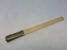 A silver-handled ivory letter opener,