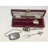 A boxed Arts & Crafts silver spoon, decanter label,