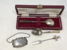 A boxed Arts & Crafts silver spoon, decanter label,