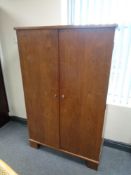 A mid century stained beech double door cupboard