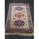 A golden Aztec design kashmir rug 120 cm x 170 cm