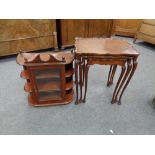 A nest of three mahogany tables together with a glazed door wall mounted cabinet