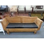 An antique pitch pine hall settee