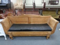An antique pitch pine hall settee