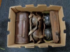 A box of three pairs of vintage wooden lawn bowls in leather bags