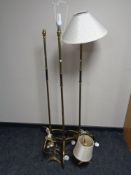 A set of three 1930's brass standard lamps on tripod bases together with a pair of similar table