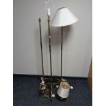 A set of three 1930's brass standard lamps on tripod bases together with a pair of similar table