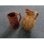 Two antique glazed pottery embossed jugs
