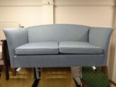A twentieth century two seater settee in blue fabric