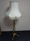 A brass Arts and Crafts rise and fall standard lamp with shade