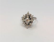 A fine 18ct white gold diamond cluster ring, the principal stone approximately 0.