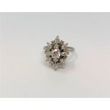 A fine 18ct white gold diamond cluster ring, the principal stone approximately 0.